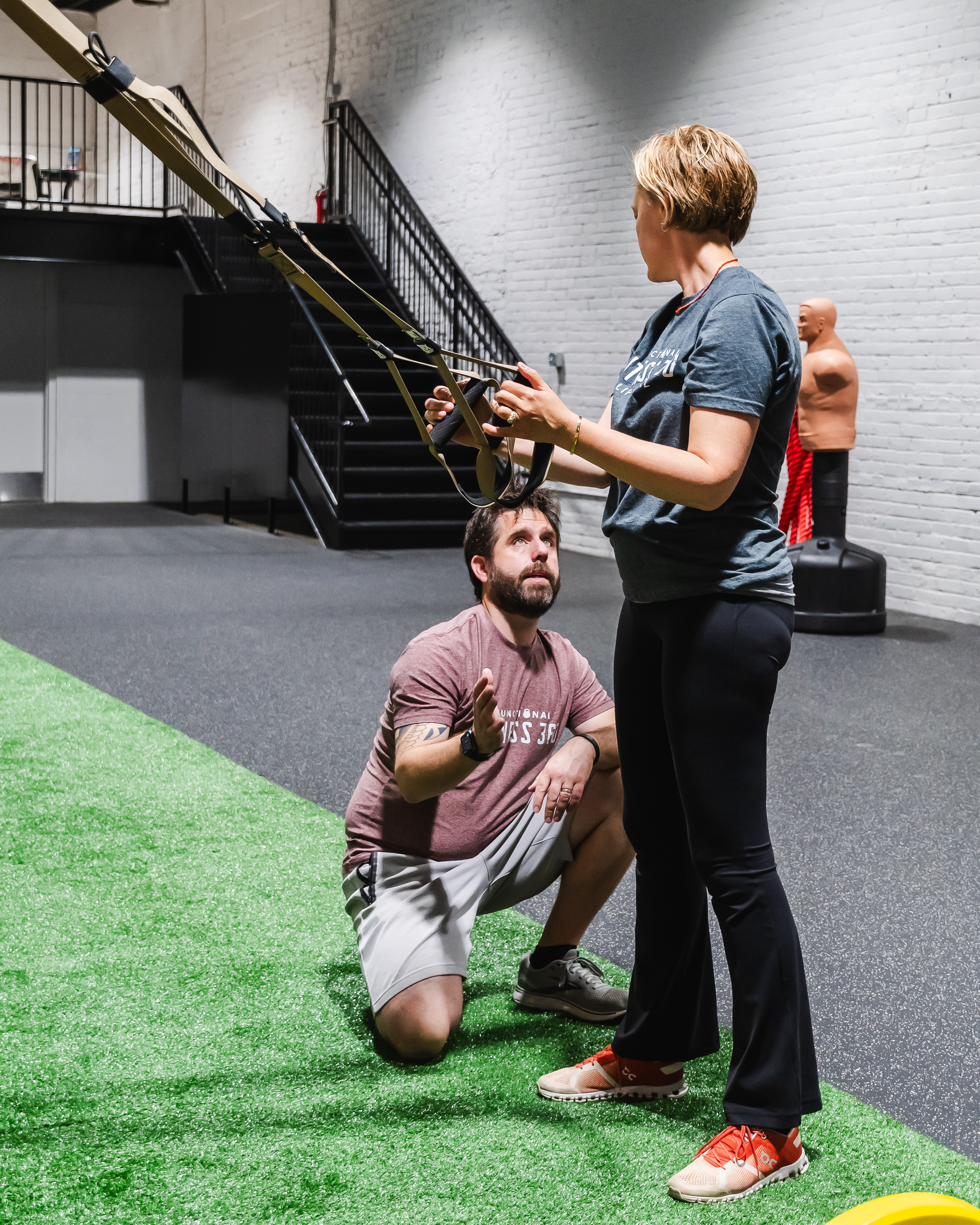 Coach working with a client on TRX training at Functional Fitness 360