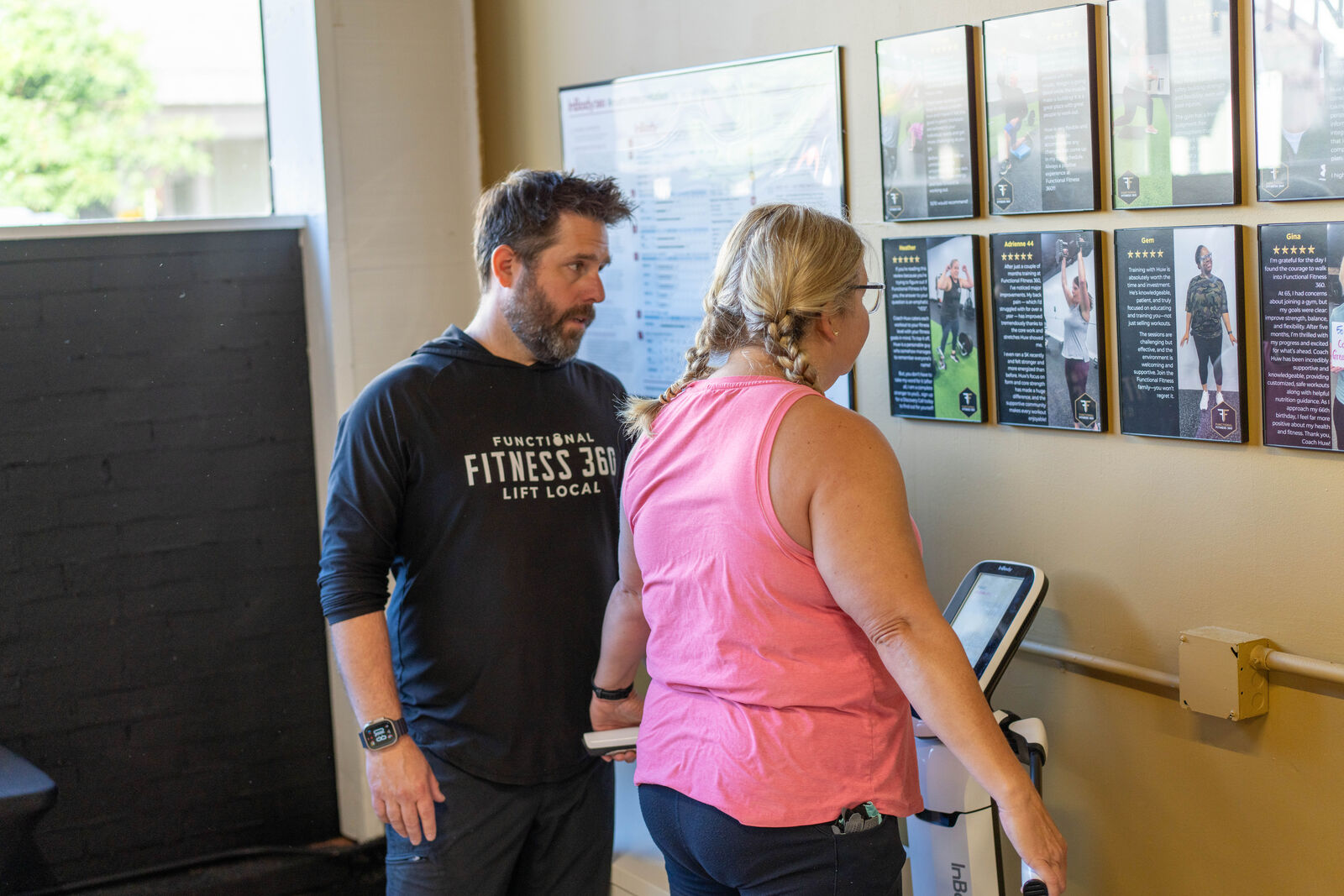 Coach Huw talking a member through her training plan