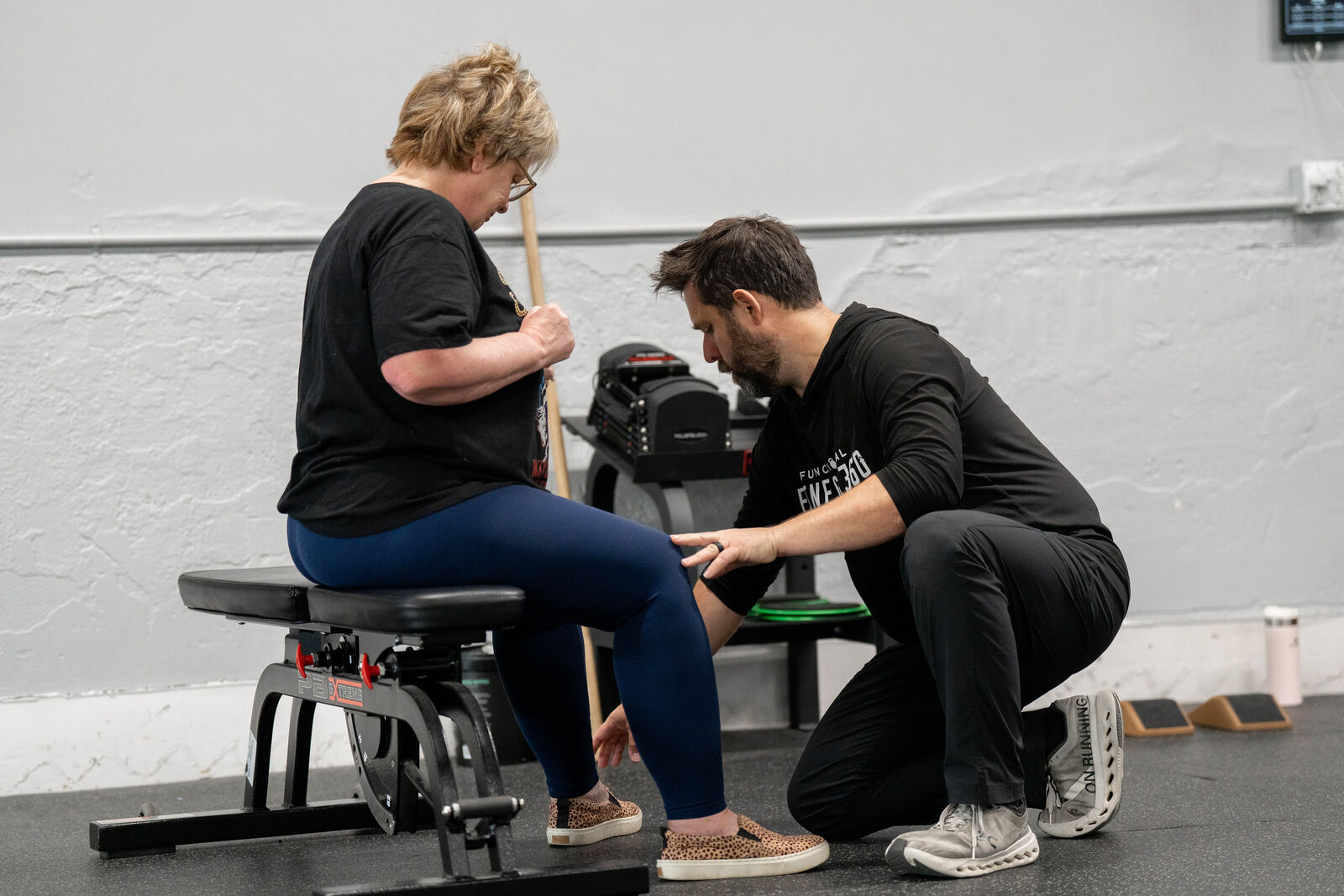 Coach working one-on-one with a member during her first movement screening