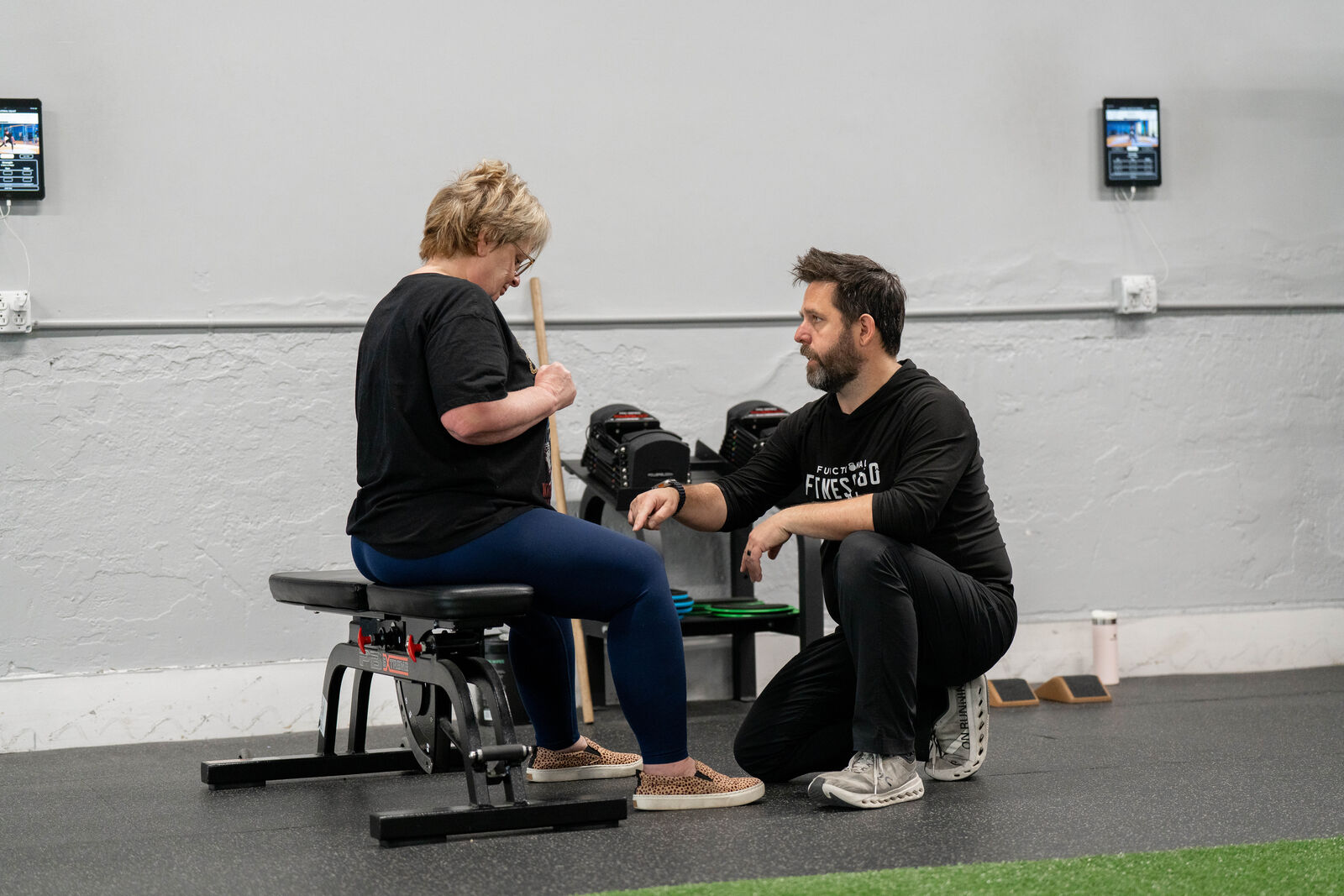 Coach Huw guiding a member through a movement screening