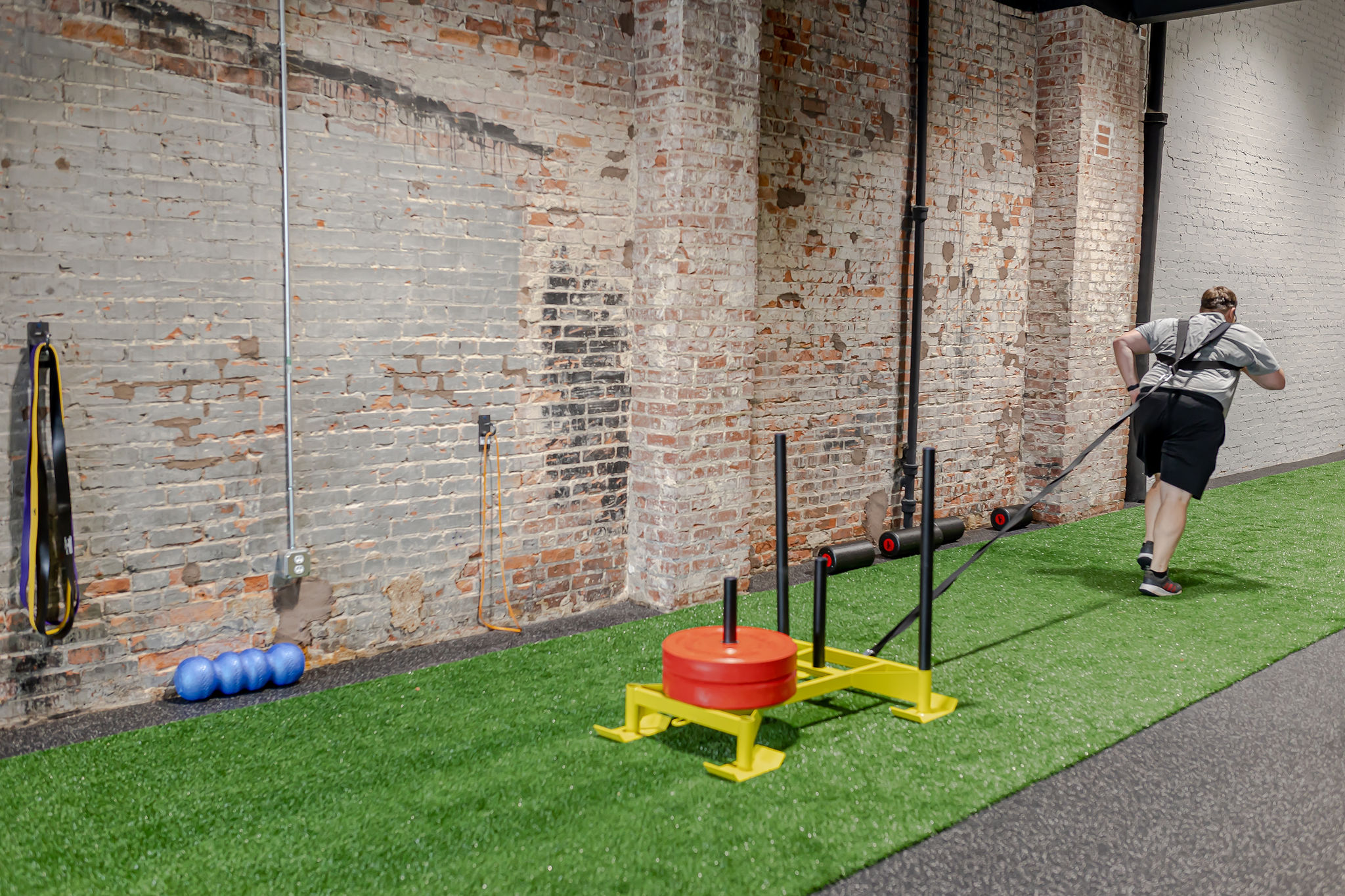 Member performing a sled pull exercise at FF360