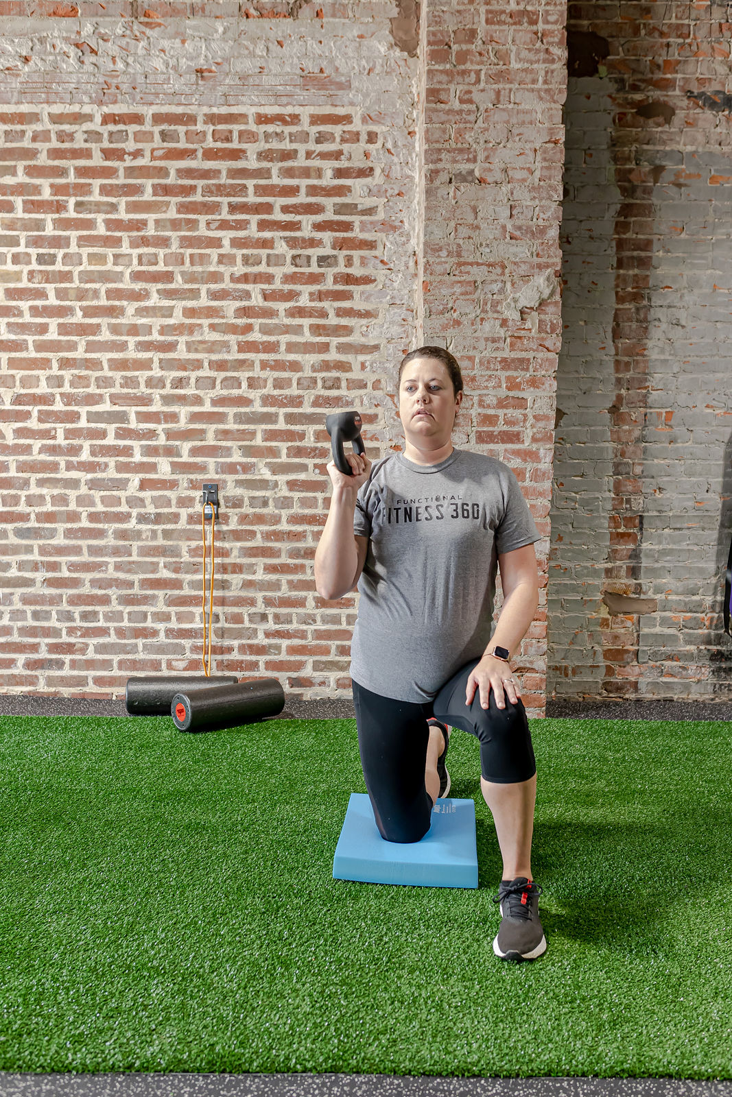 Member performing a coached split squat with proper form